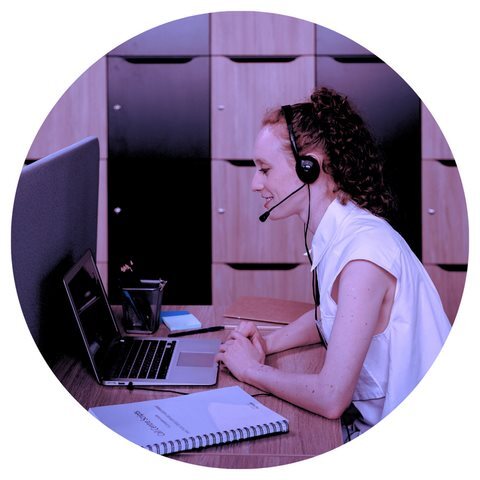 Woman talking on headset looking at computer